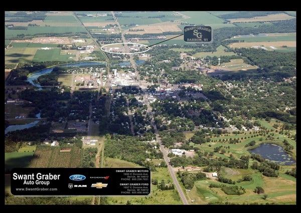 Aerial view of Barron, WI, with a highlighted area and an overlay featuring Swant Graber Auto Group branding.